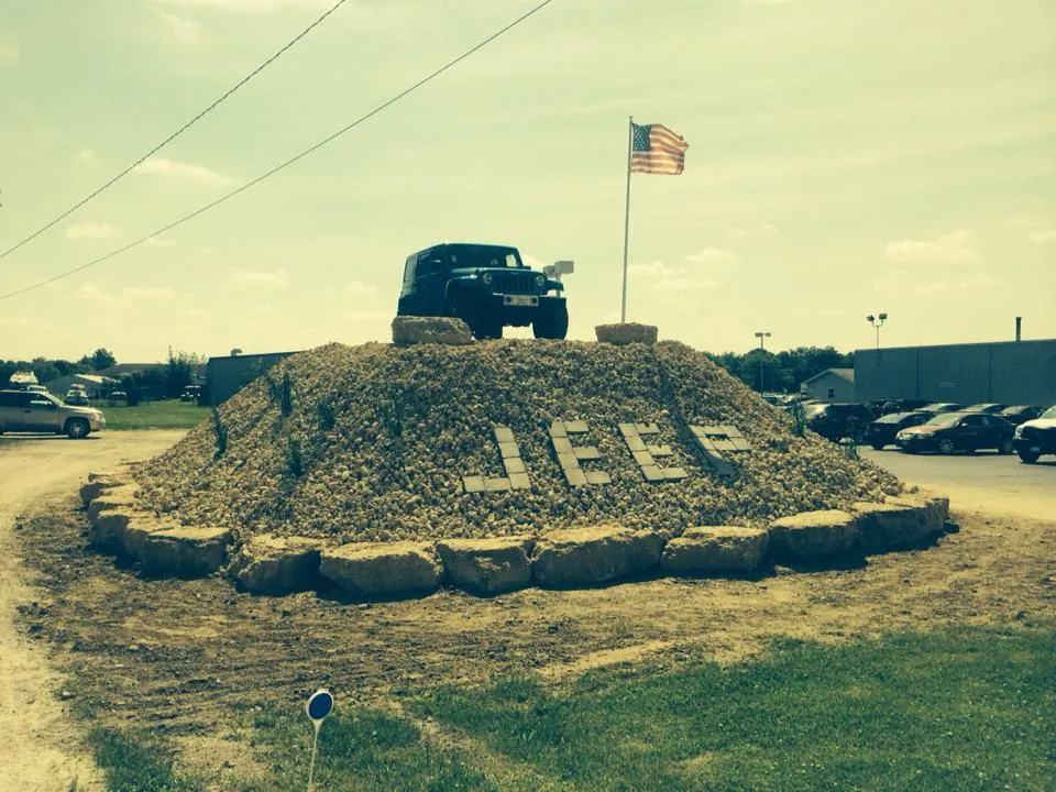 Dravis Landscaping crew hauling rock on a job site